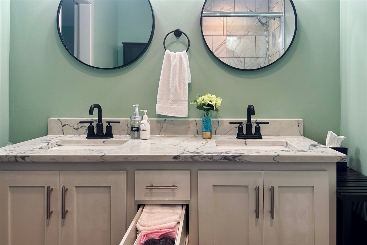 Ensuite vanity drawer stocked with hand towels, washcloths, and makeup remover cloths to enhance comfort during your stay.