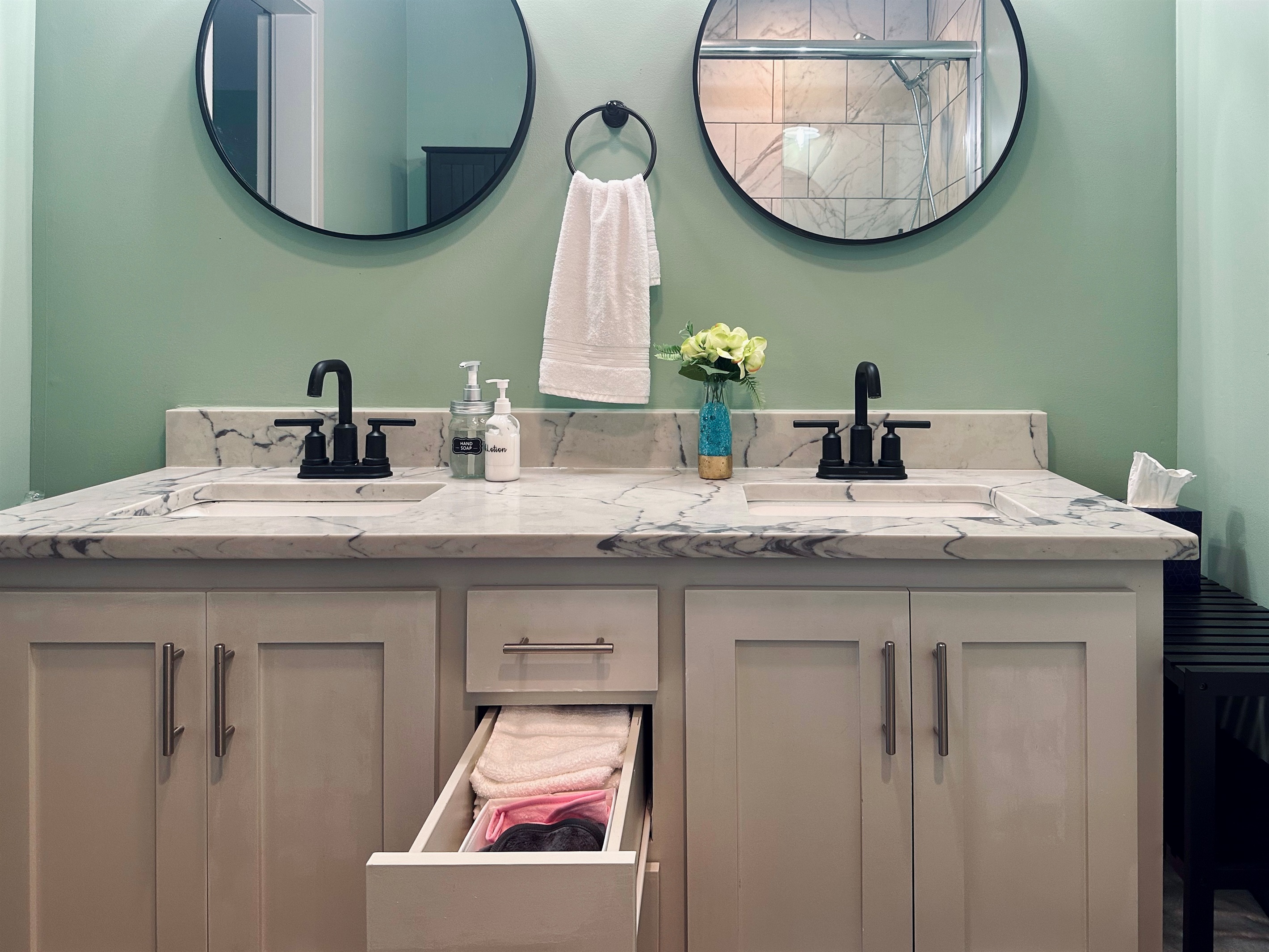 Ensuite vanity drawer stocked with hand towels, washcloths, and makeup remover cloths to enhance comfort during your stay.
