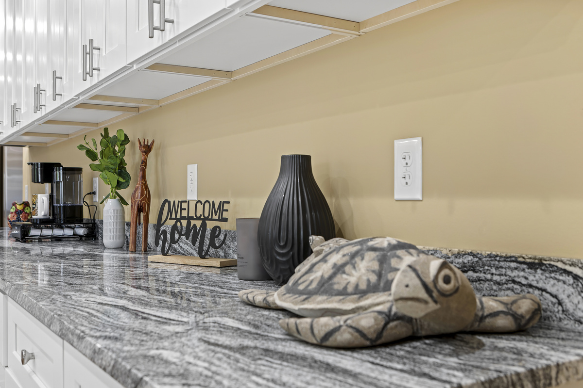 Kitchen: Bright granite counters with charming decor invite culinary adventures!