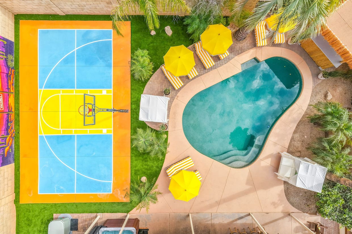 Straight-down drone view captures the pool and sport court.