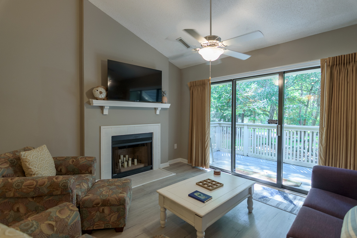 Comfortable living room with large TV and deck access