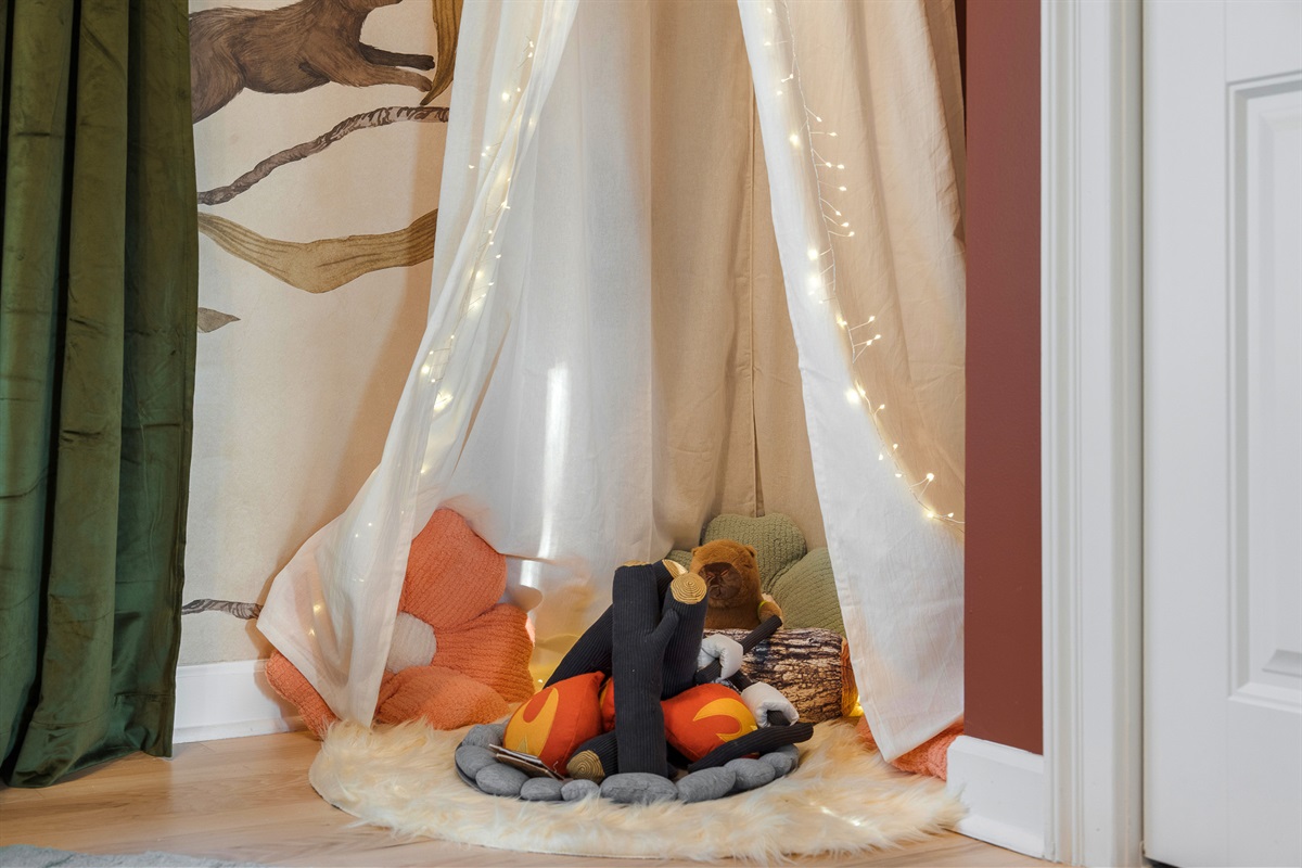 Kids play nook with soft lighting and cozy setup - thoughtful touches throughout the home for families