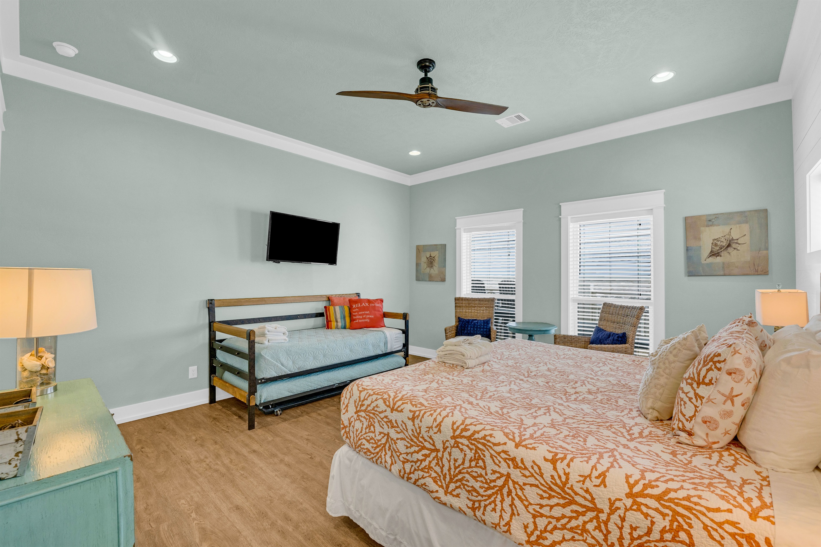 Sea It All: Primary bedroom is well appointed, w/ twin trundle bed, added seating, SMART TV and plenty of natural light. 