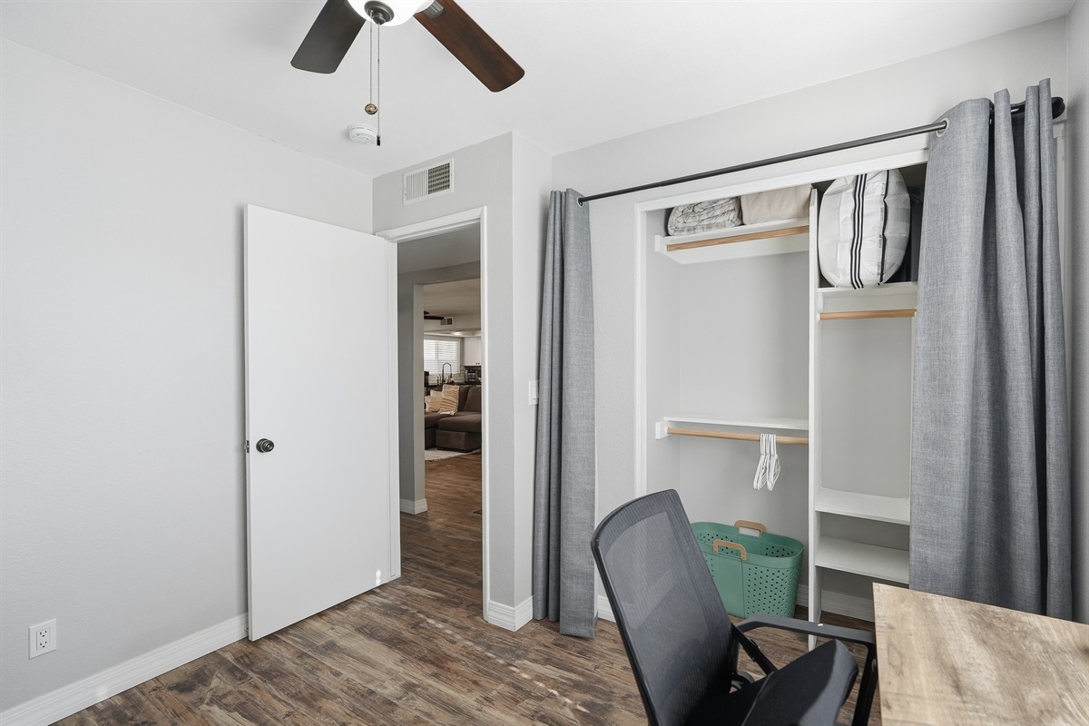 Thoughtfully designed office-bedroom with ample storage, work desk, and flexible sleeping space