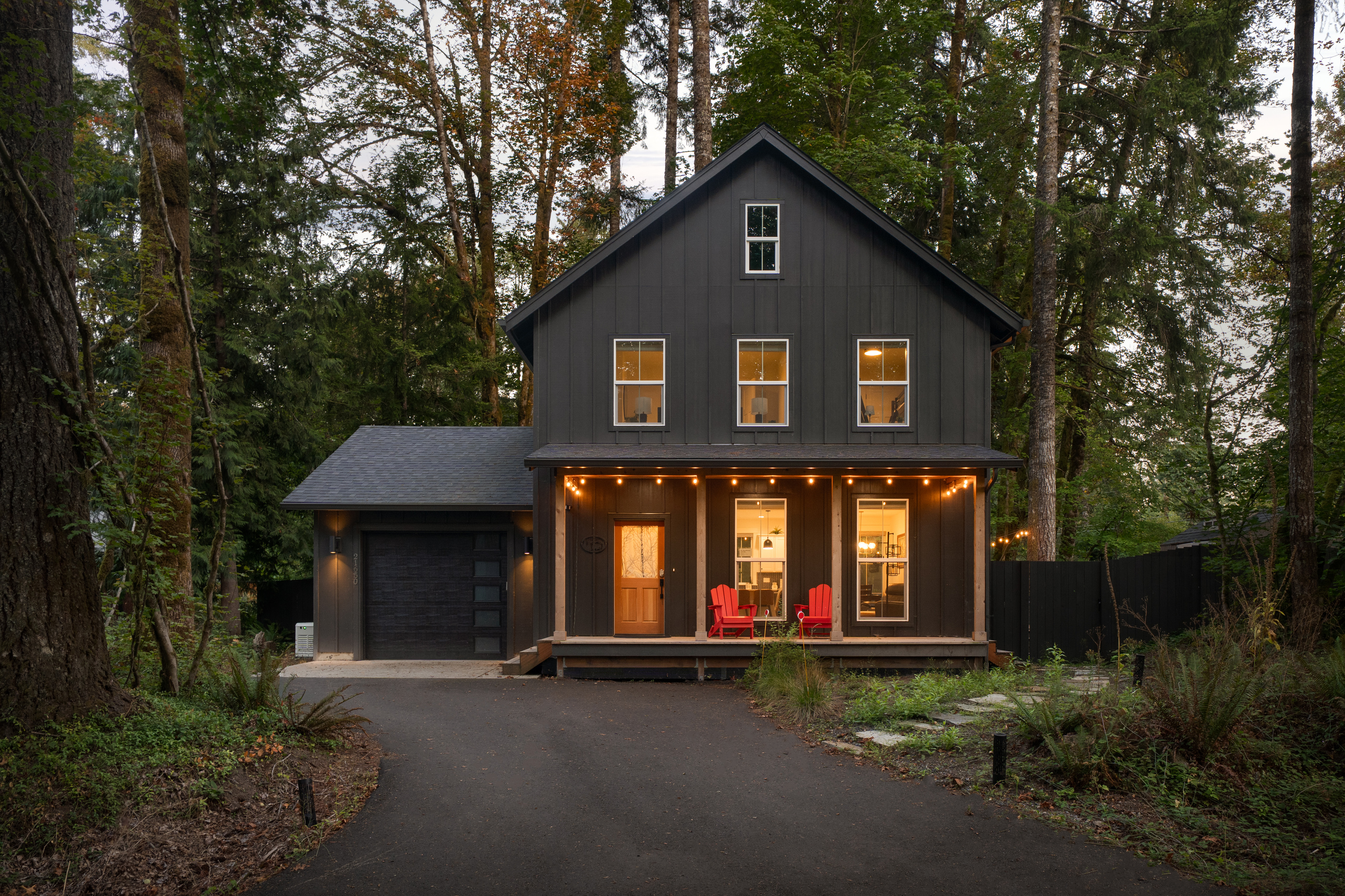 Warm lights, red chairs, deep woods — your Rhododendron cabin welcomes you home.