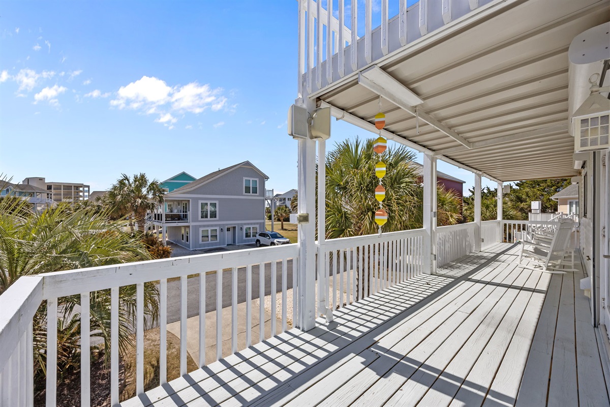 Wide balcony with seating and outdoor space to unwind after a day at the beach