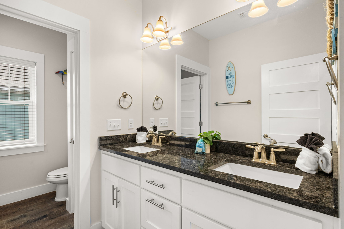 Hallway shared full bathroom with tub/shower combo — ideal for families traveling with kids