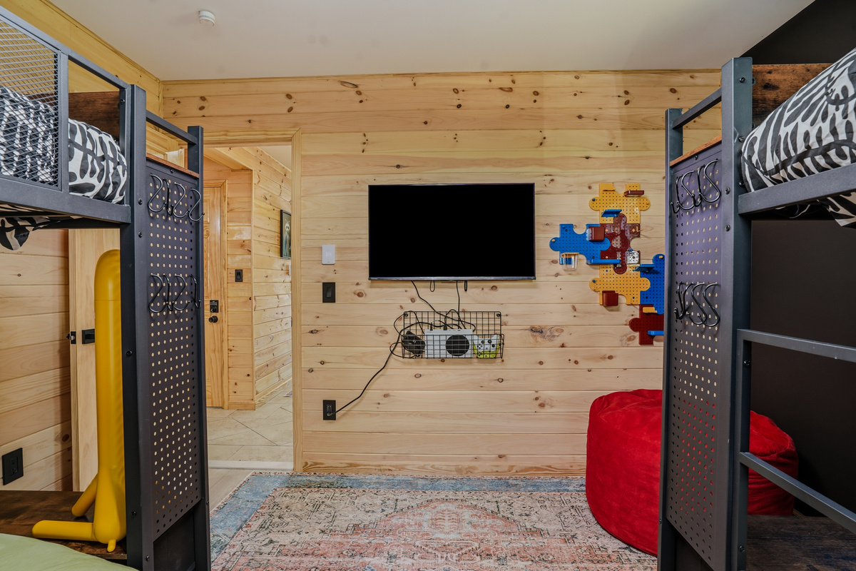 Kids & Teens Suite — Smart TV wall, Xbox, wood paneling, and playful décor