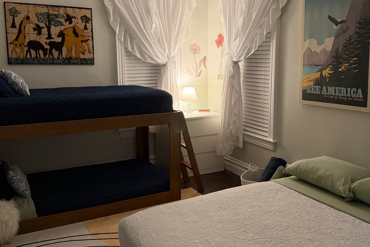 cozy twin over twin bunk with a full bed makes this family friendly bedroom