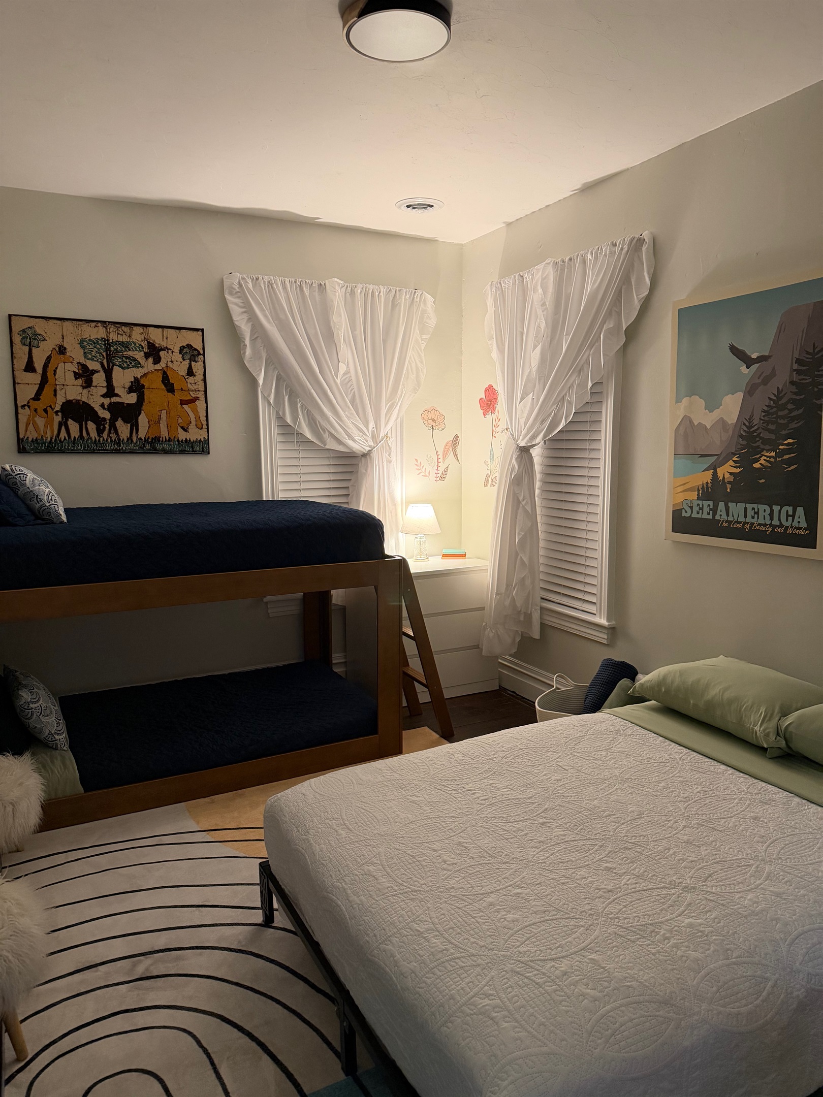 cozy twin over twin bunk with a full bed makes this family friendly bedroom
