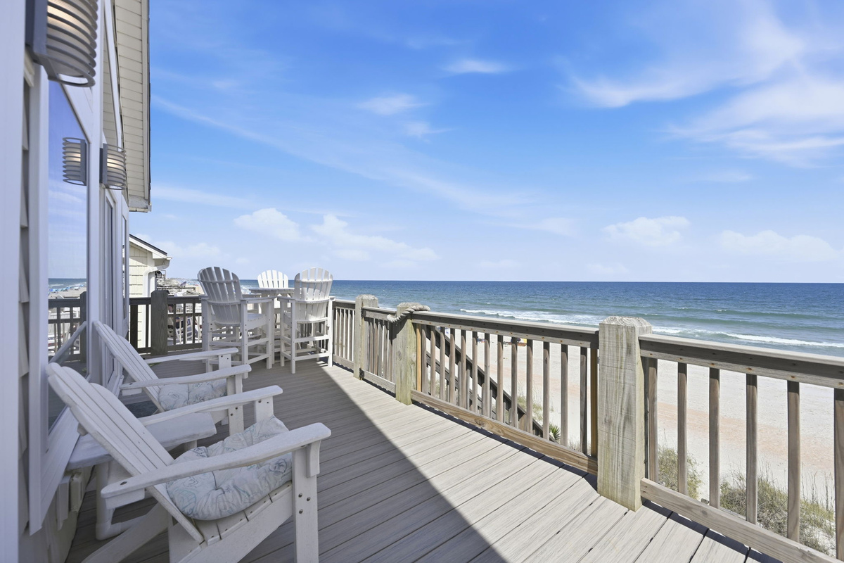 Beachfront deck with surfboard bench seating and coastal access