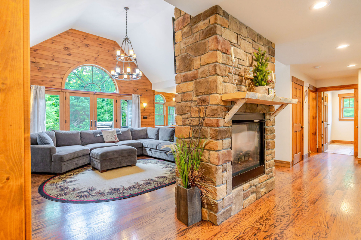 Rustic stone fireplace greets you as you enter this beautiful mountain getaway.