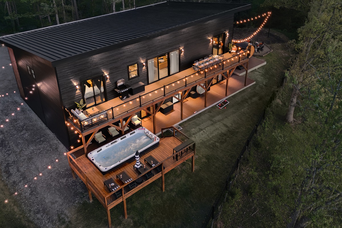 {Welcome} Nighttime at Summit House — soak in the swim spa on the elevated deck beneath glowing string lights, sharing stories over a glass of wine with mountain views all around. The perfect way to unwind and end the night.