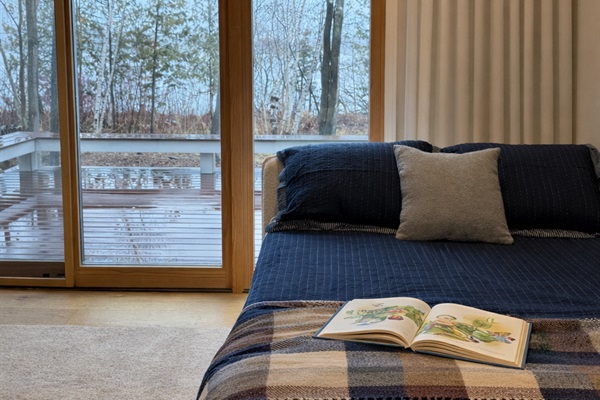 The primary bedroom has extra sleeping with a full-size daybed with trundle. Black-out drapes help everyone sleep in!