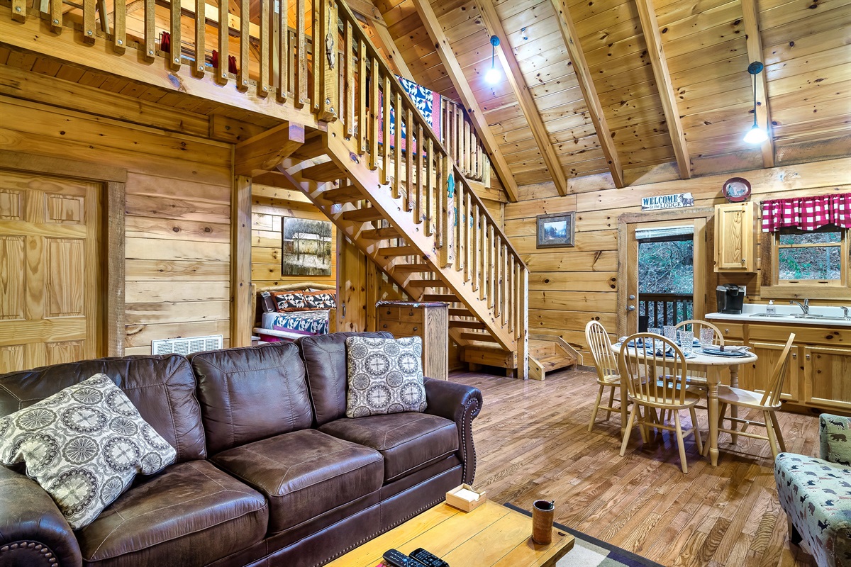 Living room with sleeper sofa and stairs to the loft