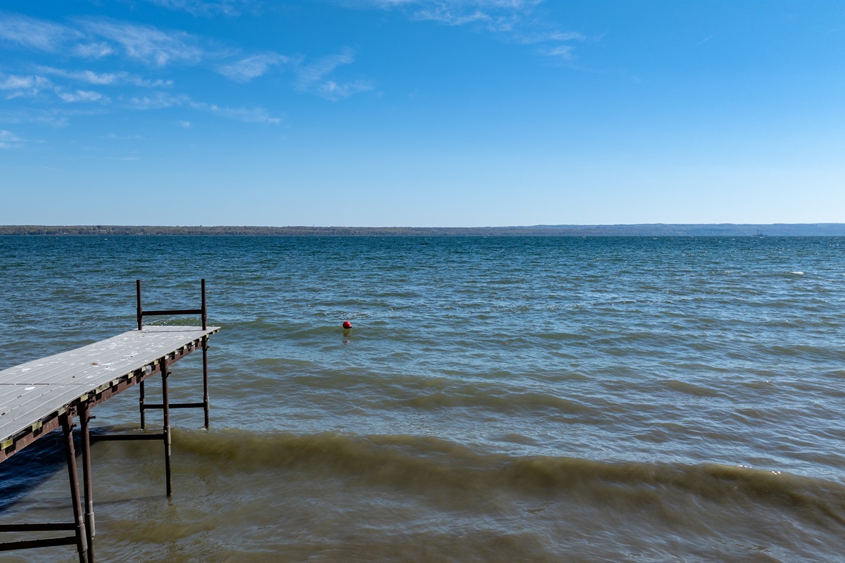 Peaceful lakefront views stretch for miles — perfect for morning coffee or sunset swims on your private dock.