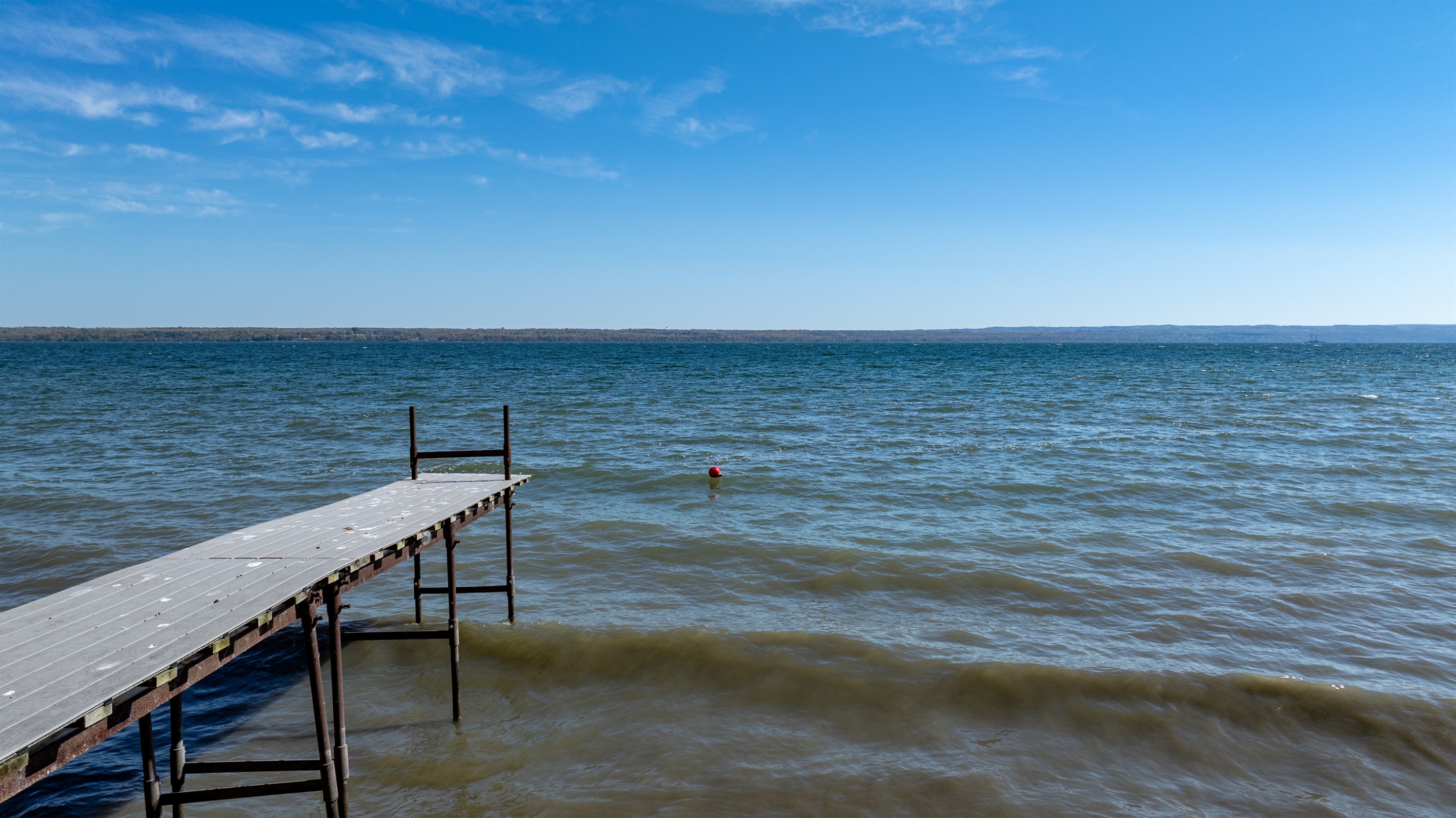 Peaceful lakefront views stretch for miles — perfect for morning coffee or sunset swims on your private dock.