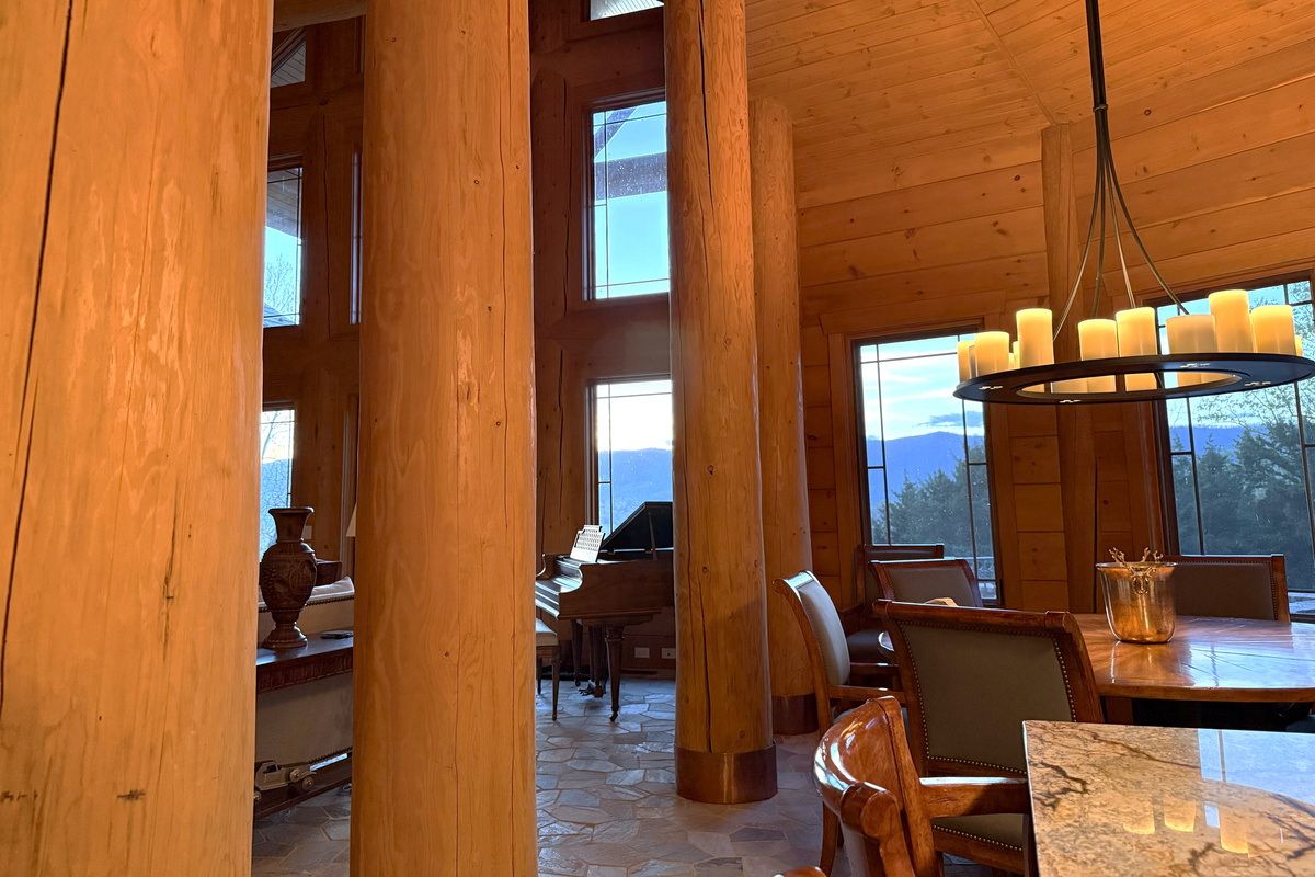 Soaring vaulted ceilings enhance the open-concept living, dining, and kitchen area, creating a spacious yet cozy mountain retreat.