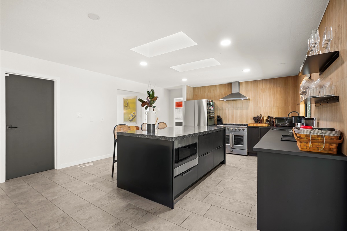 Fully equipped and thoughtfully designed, the kitchen features modern appliances, generous counter space, and everything needed to prepare meals during your stay.