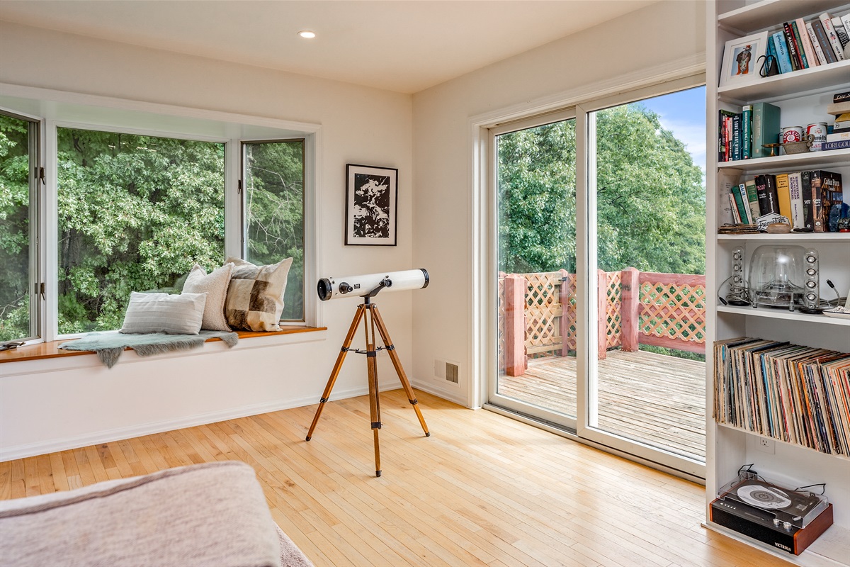 Relax in the window seat or step out onto the deck—this sunny nook invites stargazing, reading, and quiet moments