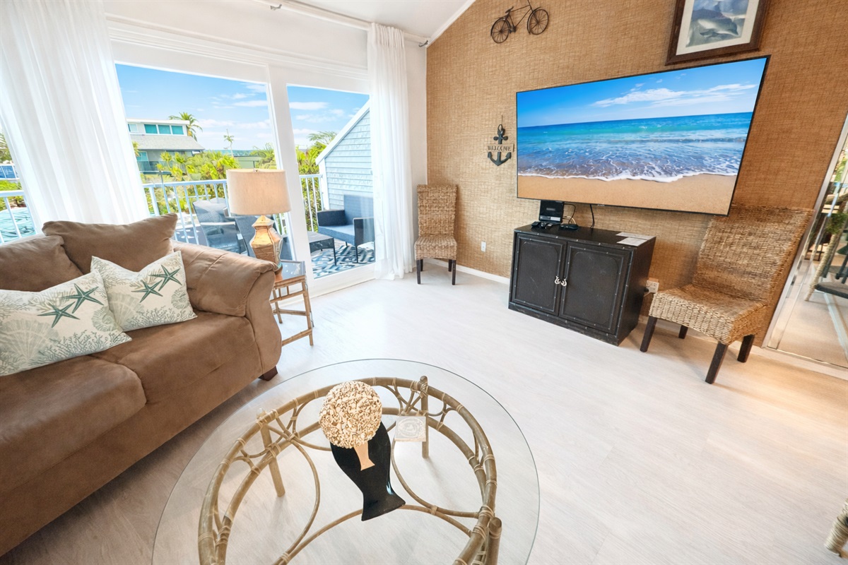 Spacious living room area with large TV!