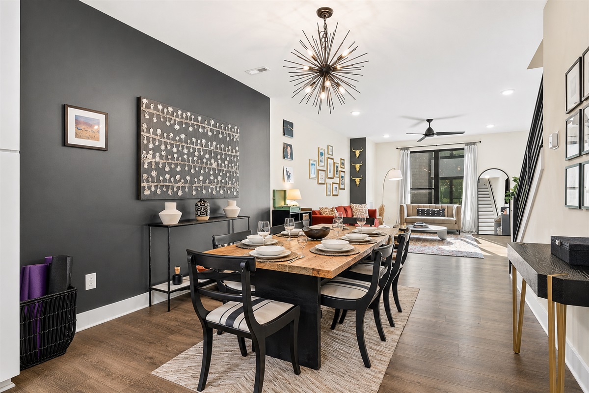 Enjoy a meal for at the dining table (updated to now have seating for 6). The open layout between kitchen, dining, and living room make entertaining easy! (Bedrooms are upstairs for good living and sleeping separation.)