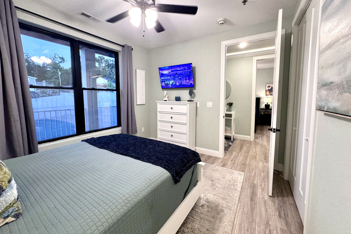 Bedroom 3 has a comfy queen bed, RokuTV, closet, two nightstands, table lamps, a dresser, an alarm clock, all bedding linens, extra pillows, a blanket, and an extra set of sheets.
