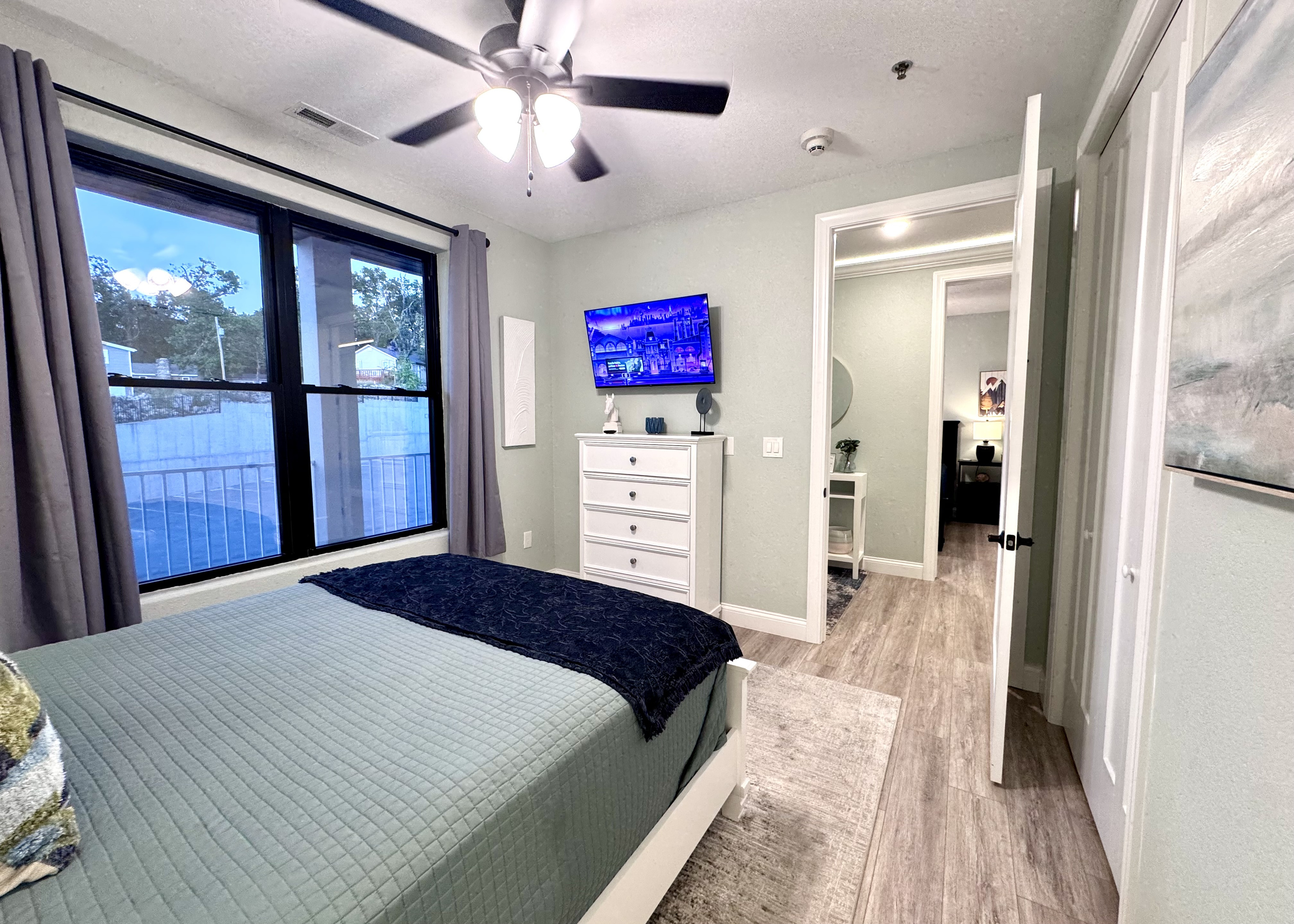 Bedroom 3 has a comfy queen bed, RokuTV, closet, two nightstands, table lamps, a dresser, an alarm clock, all bedding linens, extra pillows, a blanket, and an extra set of sheets.