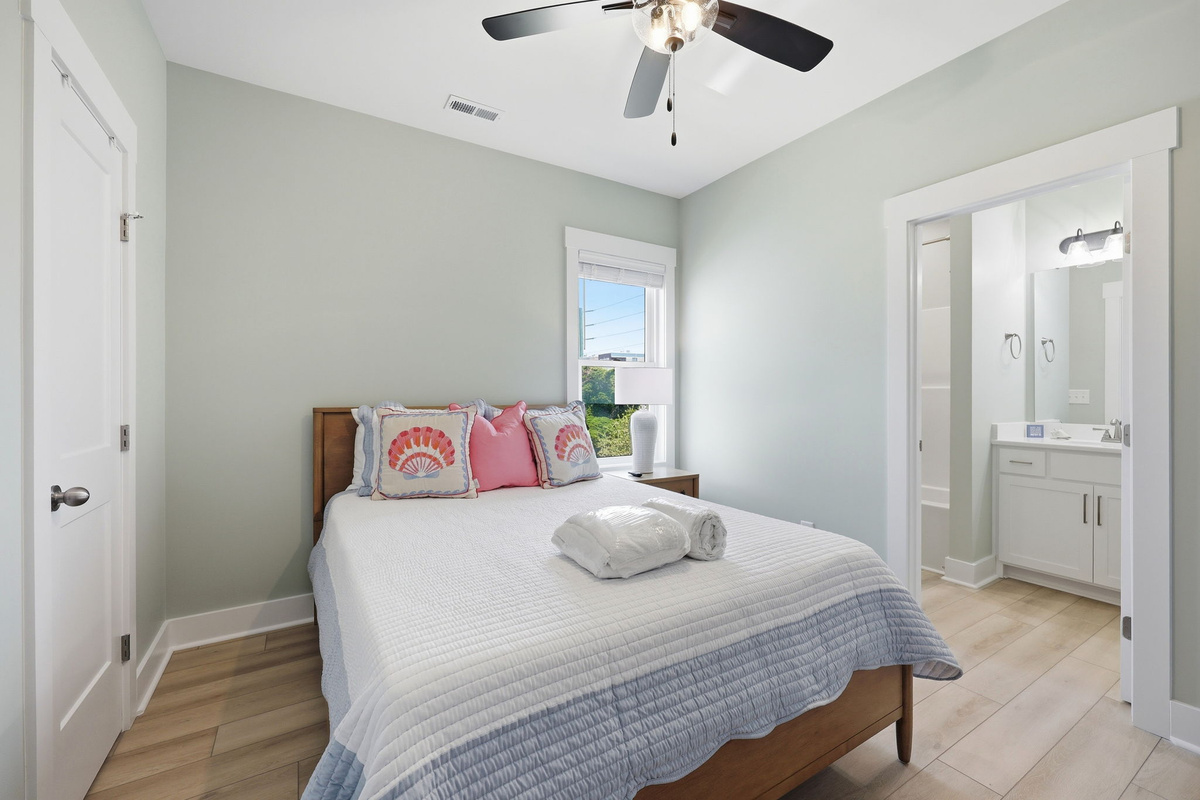 A comfortable queen bedroom on the first floor offers a peaceful retreat with an en-suite bathroom