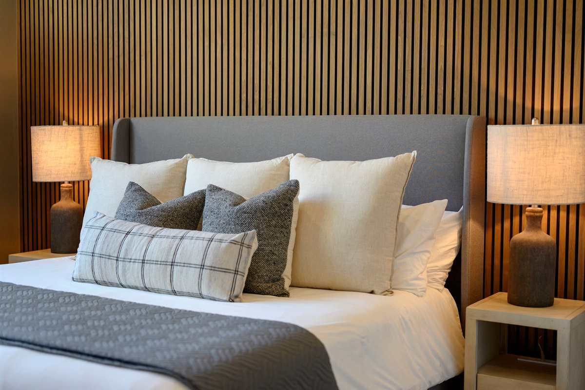 King Suite 2 - Large and spacious suite with teak wood paneling, designer finishes, smart TV, premium king mattress, and luxury bedding. Includes stunning views of the hardwood forest. 
