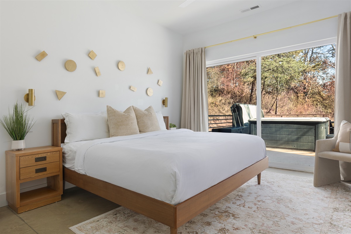 {King Suite - Gallery House} A sunlit bedroom with layered textures and direct access to your private hot tub—relaxation begins the moment you wake.