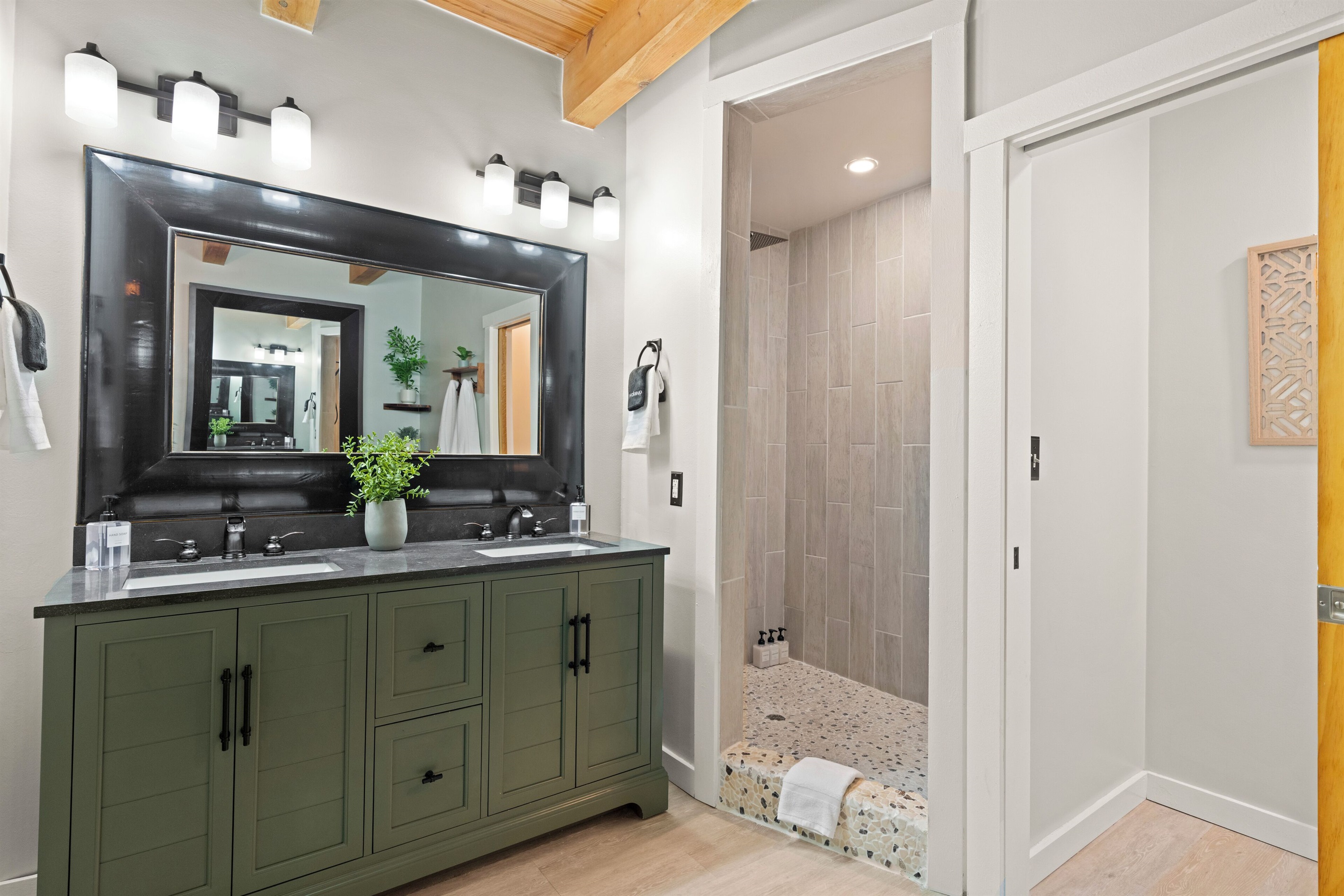 Ensuite bathroom to BR1 with heated floors, double vanity, tile shower and tub