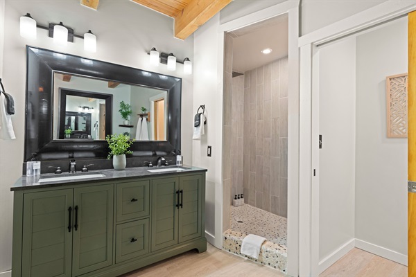 Ensuite bathroom to BR1 with heated floors, double vanity, tile shower and tub