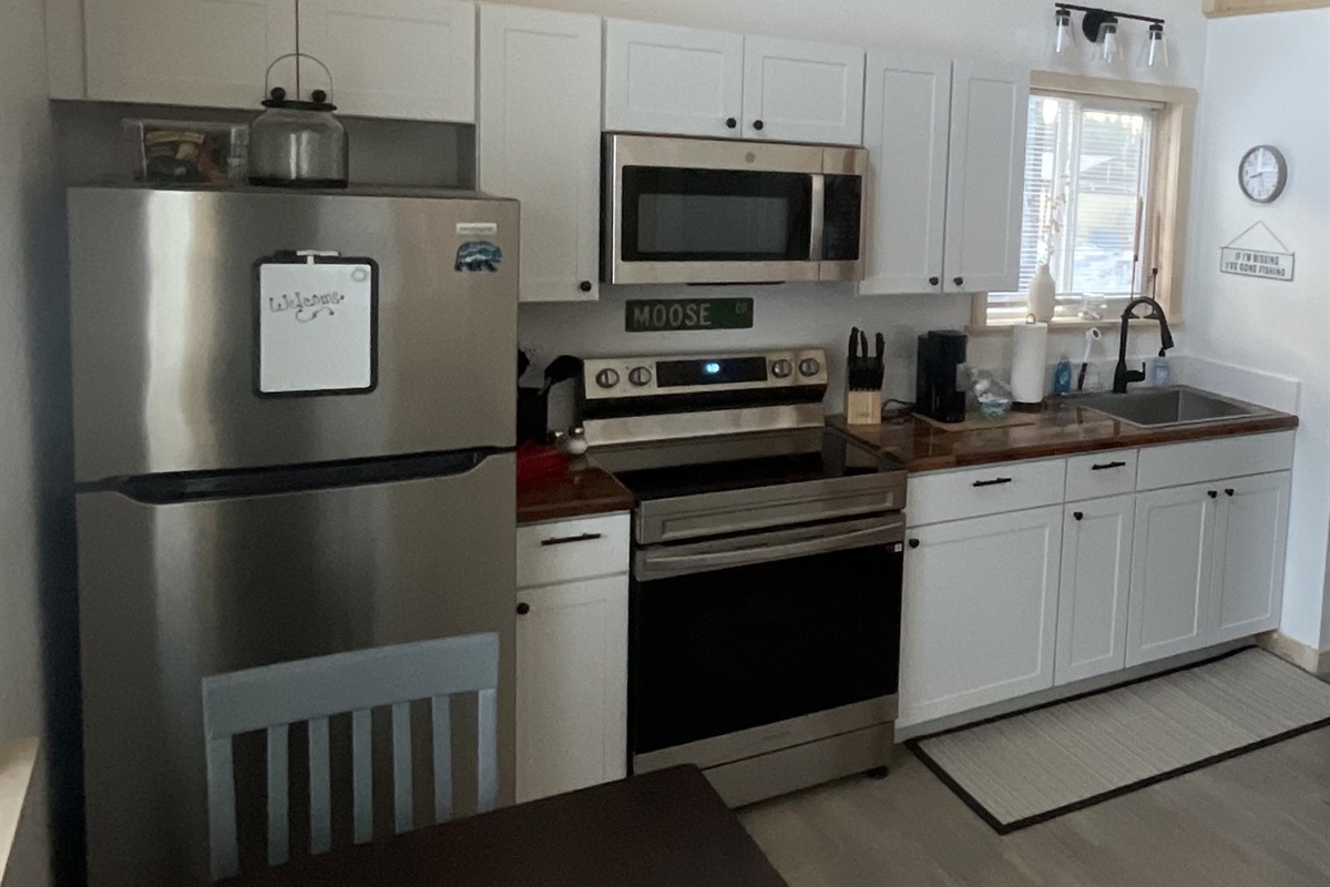 Kitchen includes an electric range, microwave, refrigerator, and Keurig.