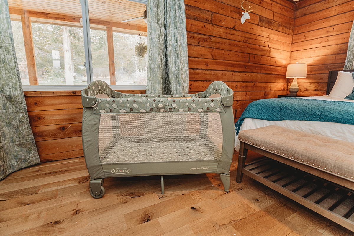 A cozy playpen with crib sheets offers a comfortable and secure space for your little one to sleep or play.