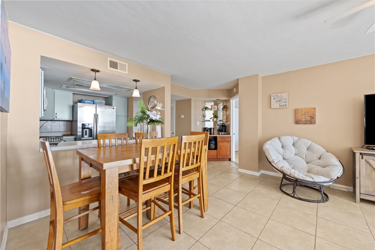Spacious dining area with seating for six, conveniently located next to the kitchen and open to the living space for easy gatherings