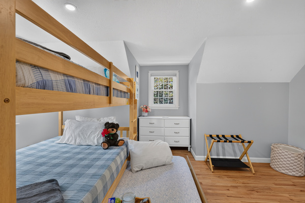 Spacious bunk room with plenty of floor space for luggage, play, and family comfort.