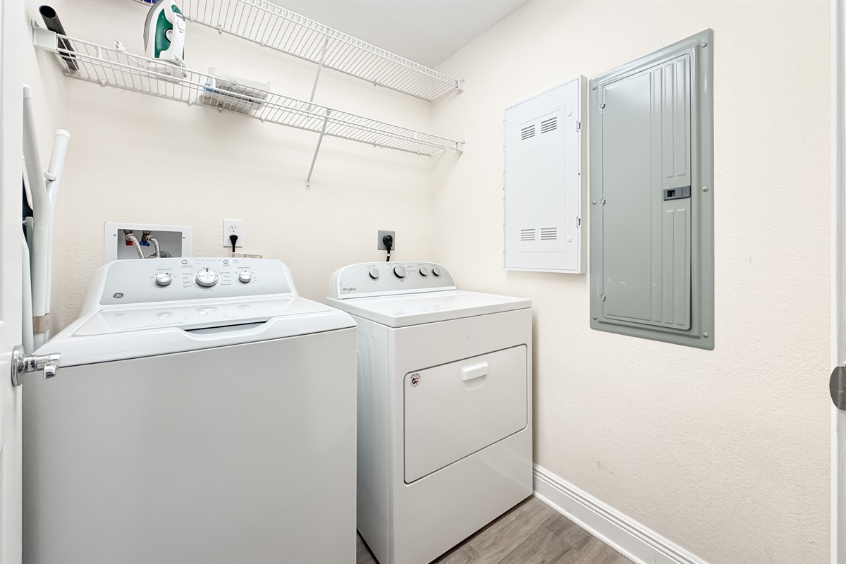 Maximize your comfort with this functional laundry area, featuring an in-unit washer/dryer and wire shelving for organized storage.