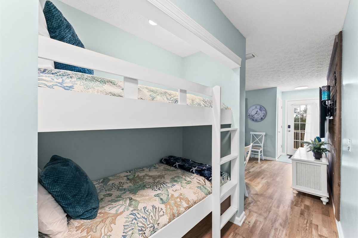 Hallway twin bunk beds — perfect for kids or extra guests, with easy bathroom access.