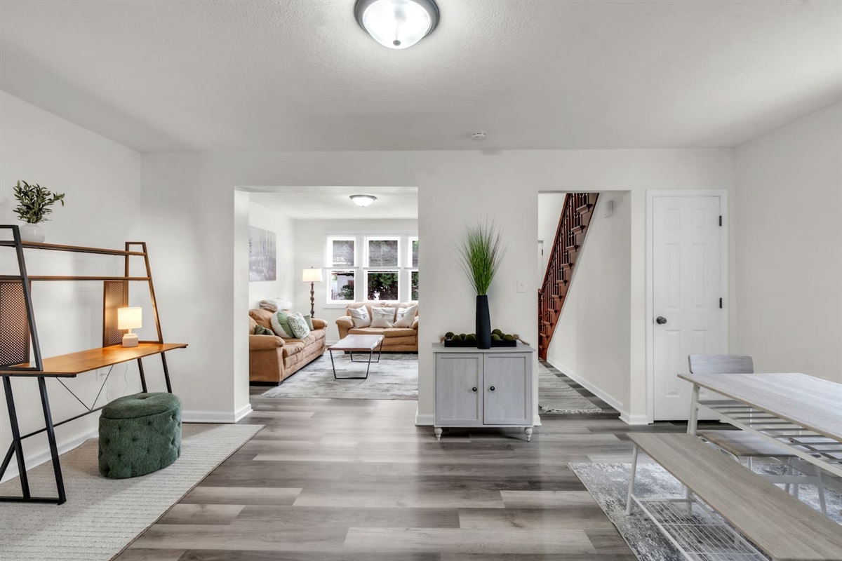 This living room features comfortable couches and a spacious window, letting in natural light to enhance the bright and tranquil atmosphere.