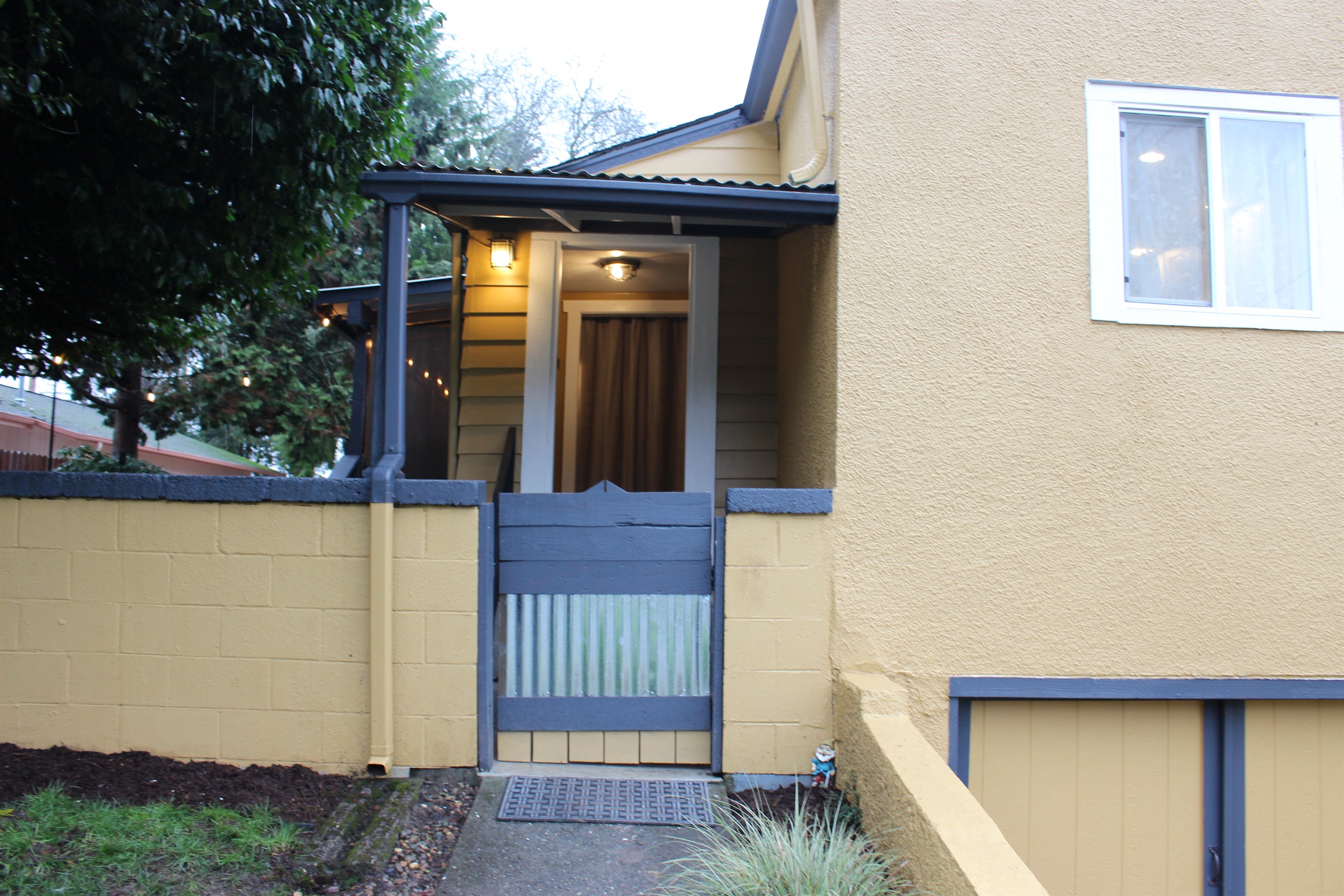 View of side porch with fenced yard. Gate opens and can be propped open per your preference