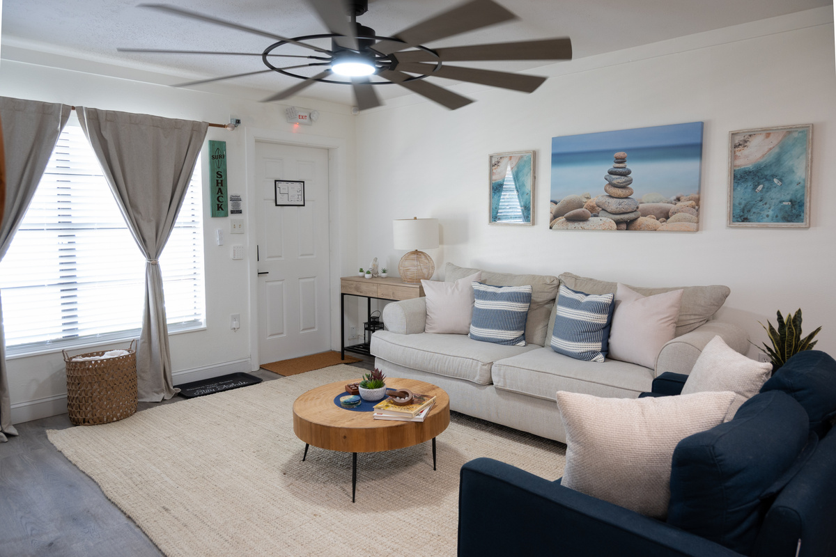 Living room from the entry – sofas, window seat and beach-inspired decor