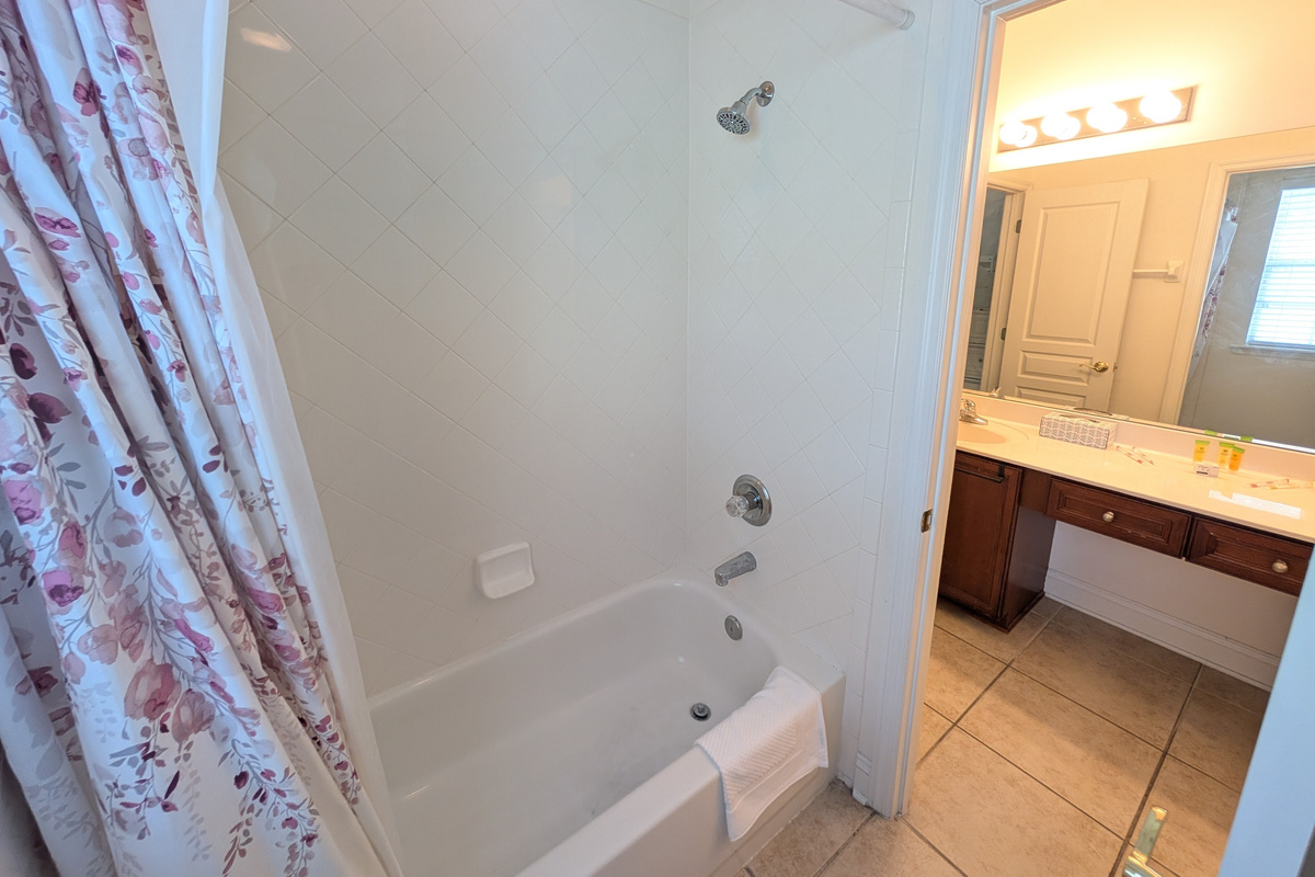 Full tub and shower combination offers a convenient option for both adults and families traveling with children.