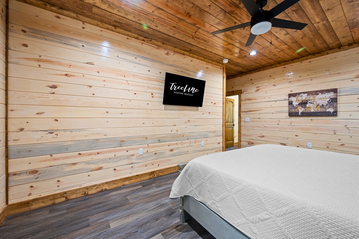 With simple décor and soft lighting, this bedroom feels welcoming and comfortable, giving guests their own private space to relax after a day full of activities.