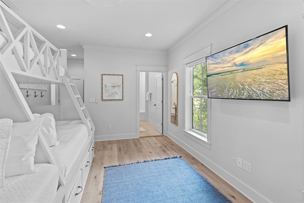 Spacious 2nd level twins over queens bunk room with full ensuite bathroom, tiled shower with tub, and a large vanity.