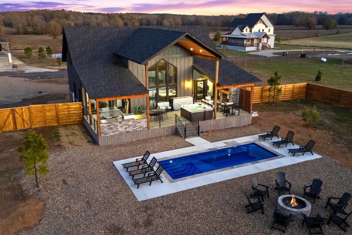An aerial look at the backyard shows the perfect setup for swimming, lounging, gathering, and enjoying outdoor time together.