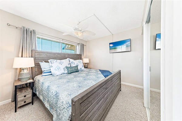 Primary bedroom with King sized bed, smart TV, closet and private full sized bathroom.
