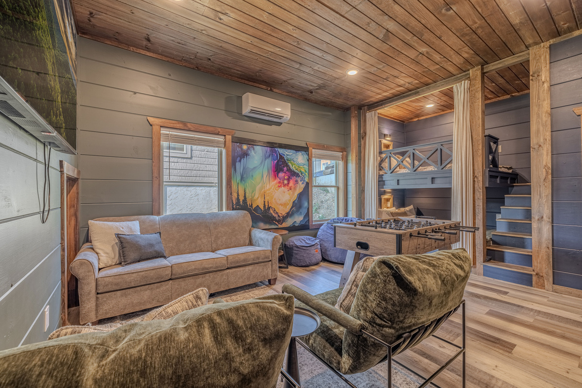 The game room offers foosball, arcade fun, and plenty of lounge seating. A pull-out sofa and beanbag that converts into a full sized bed gives you extra sleeping space.