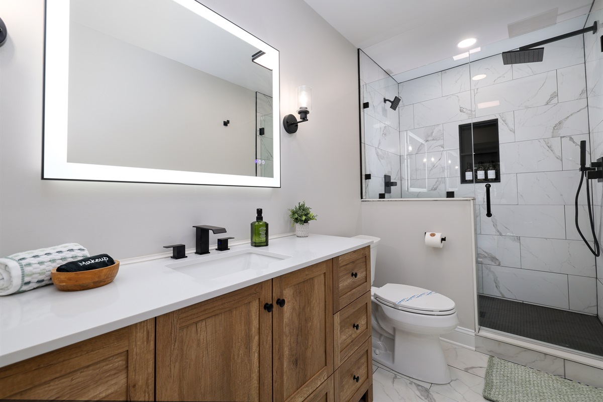 primary bathroom with rain shower and digital mirror