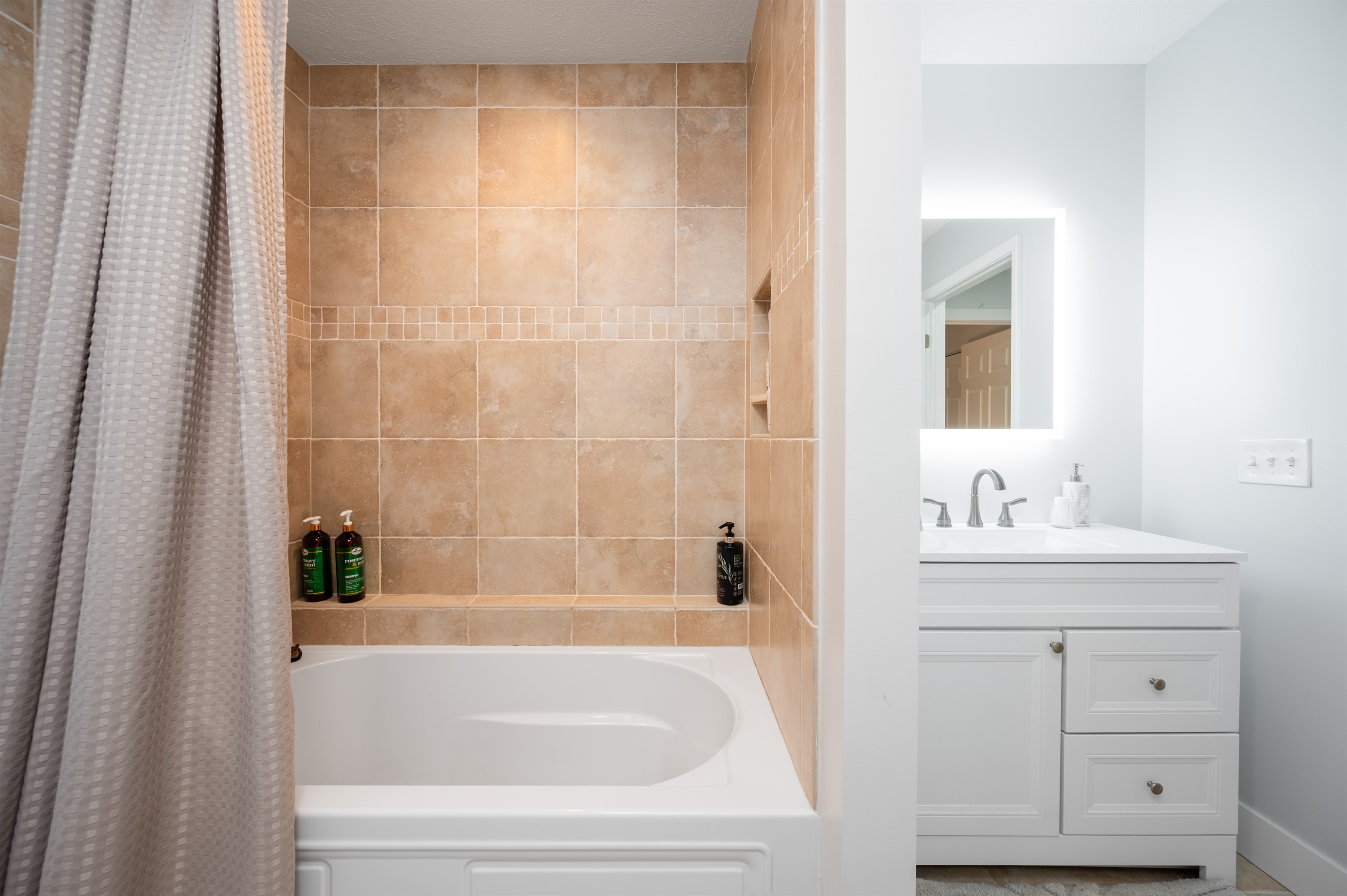 Main level Full bathroom with tub and shower